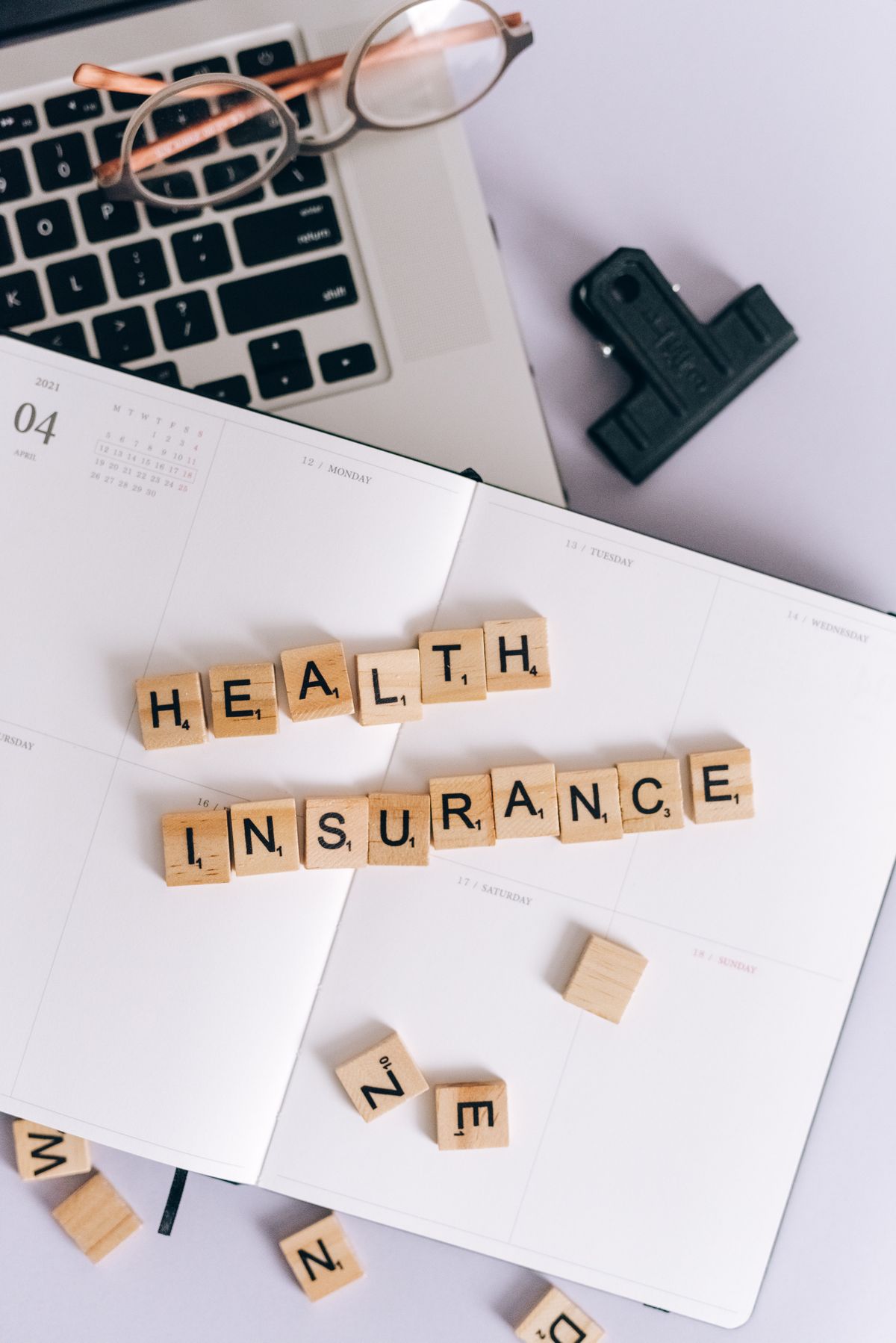Patient reviewing a dental treatment plan and insurance benefits summary at a desk with a calculator