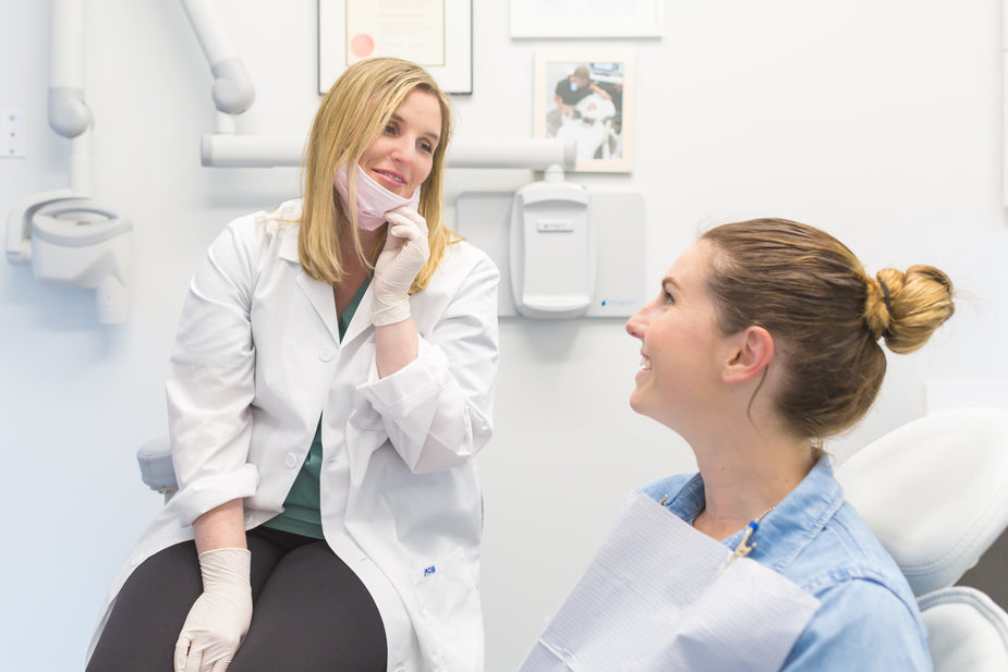 Dentist reviewing a dental X-ray with a patient during a consultation for an in-person second opinion